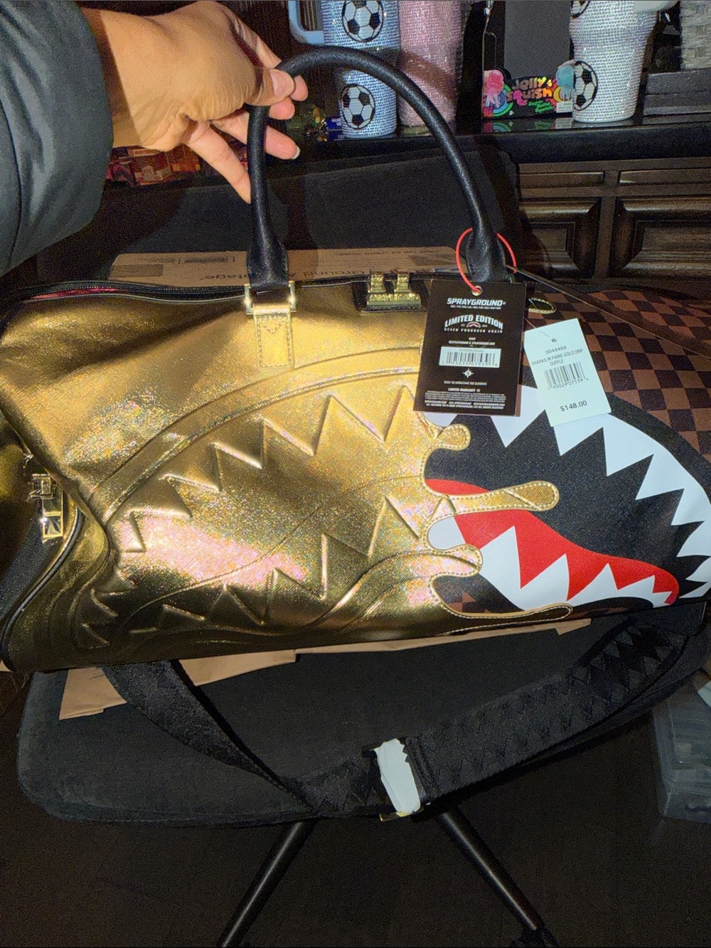 Sprayground Metallic Gold Shark Duffle with Black Handles and Red Accent